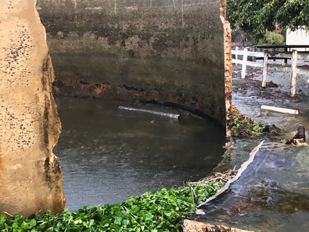 This image shows the wall of a concrete water tank after it has been blown out because the structural integrity of the tank was compromised due to cracking.