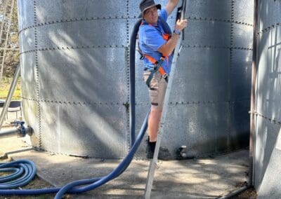 Leigh harnessed and climbing ladder onto tank