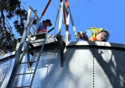 Leigh and Ryan setting up tripod to clean and inspect fire retention water tanks